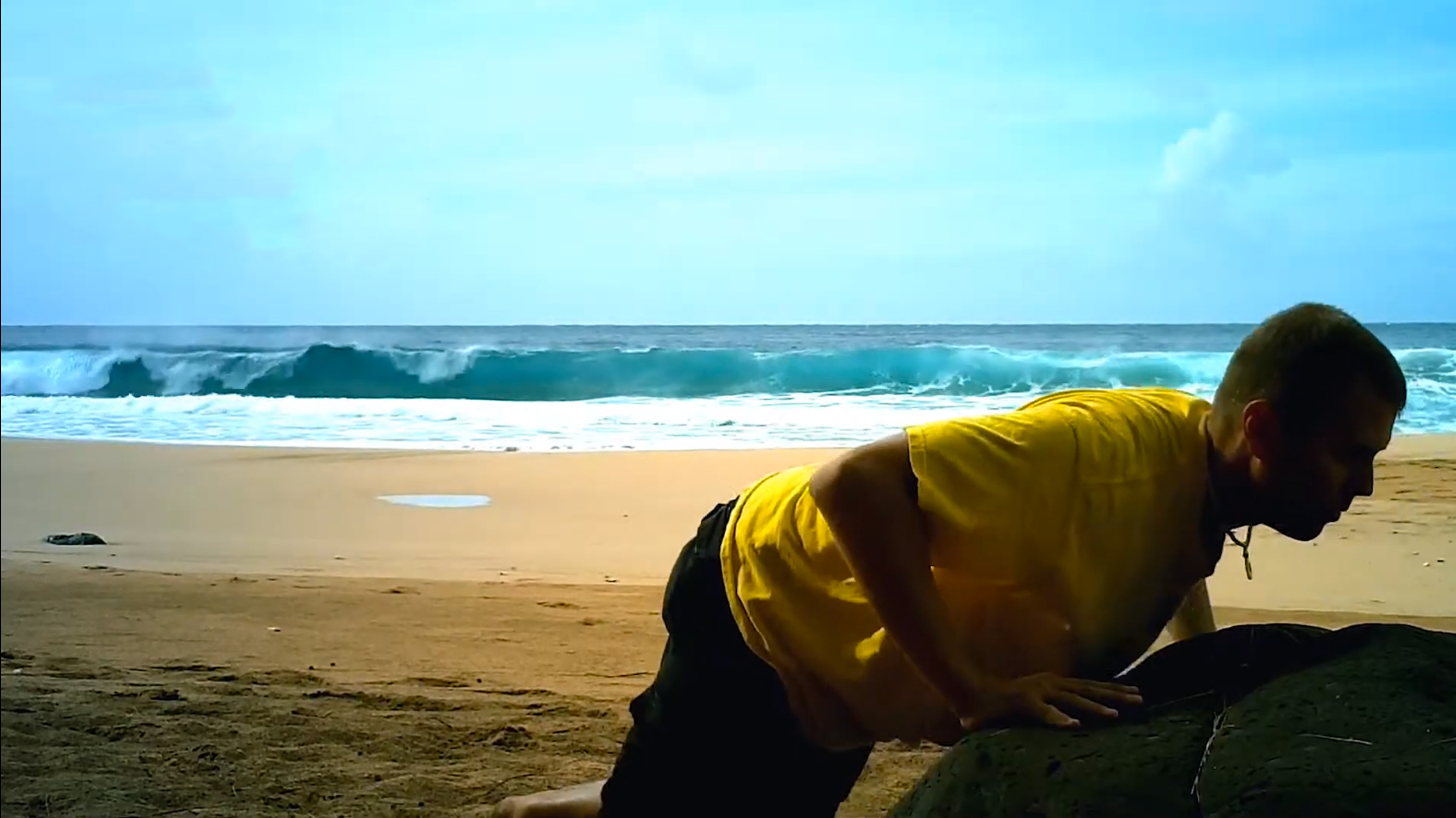 Doug Jones doing rocky push-ups at Secret Beach, Kauai